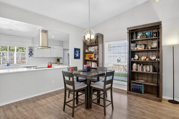 6331 North Jim Miller Road Dallas, TX 75228 - Photo 4 of 28 Dining space with light wood-style flooring and a chandelier