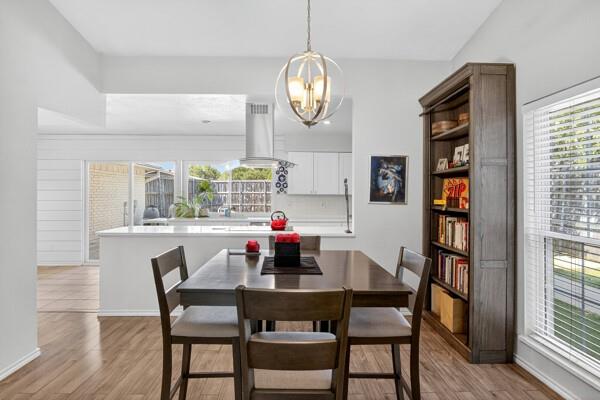 6331 North Jim Miller Road Dallas, TX 75228 - Photo 5 of 28 Dining room with light wood-style floors and a chandelier
