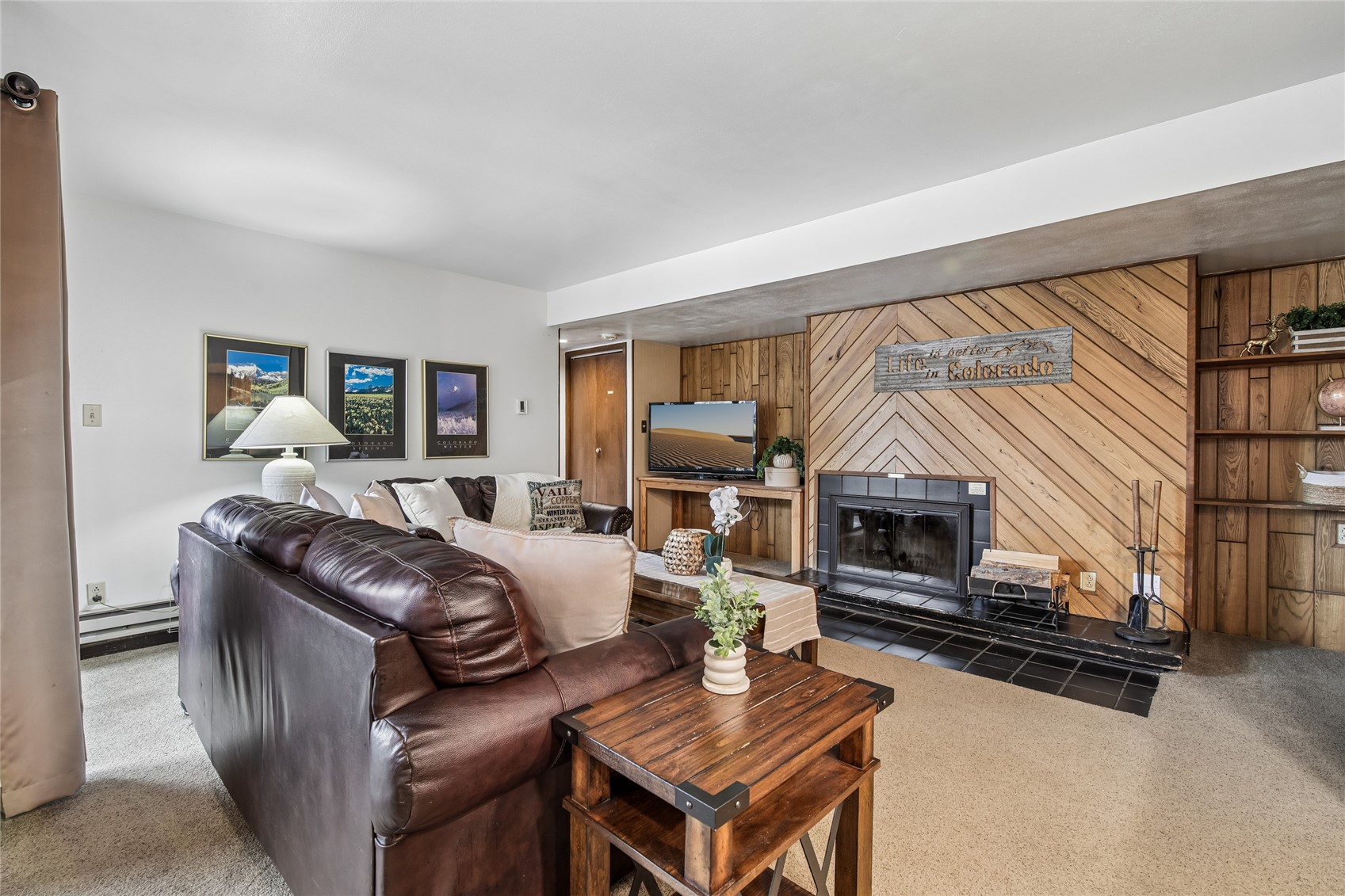 423 Wild Irishman Road, Unit 1008 1009 Keystone, CO 80435 - Photo 4 of 28 a living room with furniture a flat screen tv and a fireplace
