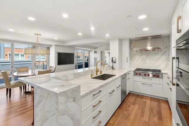 a front view of a building with lake view and tall windows