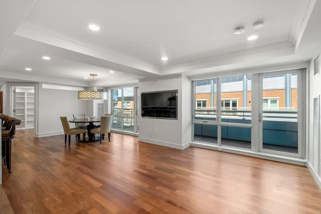 a living room with furniture and a floor to ceiling window