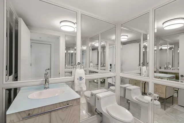 a spacious bedroom with a bed and a view of bathroom