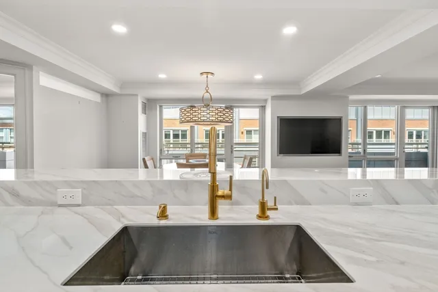 a large white kitchen with a sink and cabinets