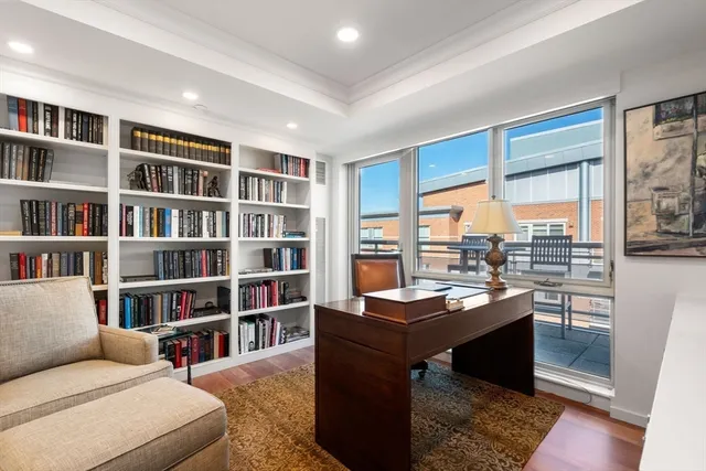 a large tub sitting in a bathroom next to a window