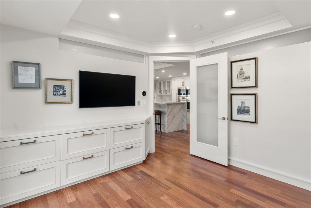 4 Battery Wharf, Unit 4604 Boston, MA 02109 - Photo 20 of 39 a living room with furniture and a flat screen tv
