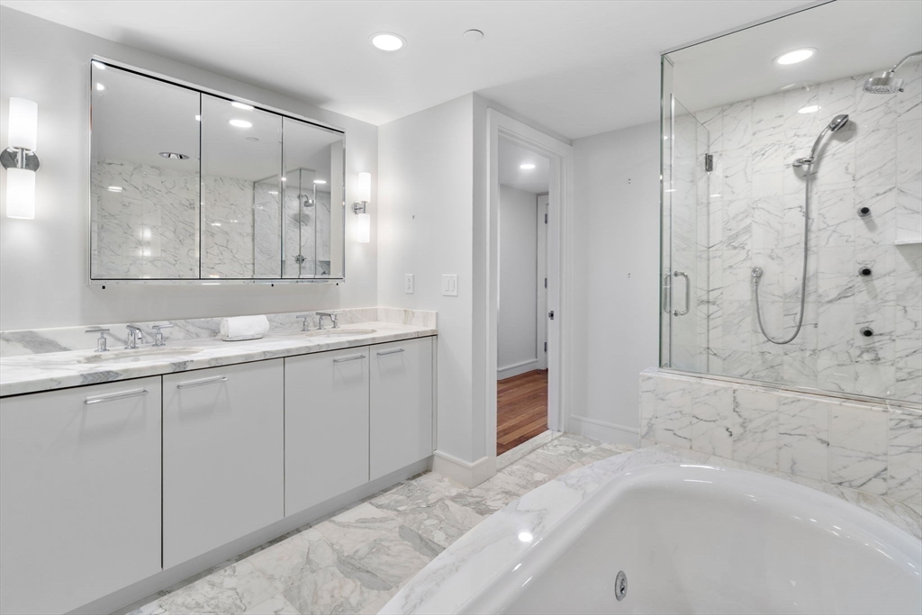 4 Battery Wharf, Unit 4604 Boston, MA 02109 - Photo 23 of 39 a bathroom with a tub sink shower and mirror