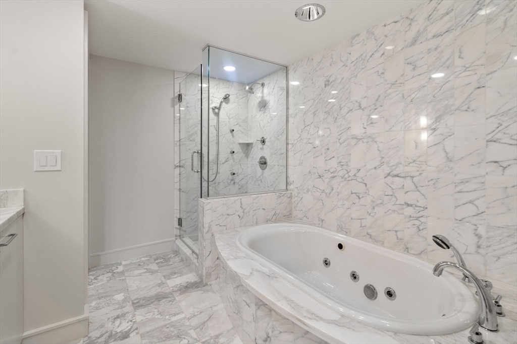 4 Battery Wharf, Unit 4604 Boston, MA 02109 - Photo 24 of 39 a bathroom with a bathtub and a shower