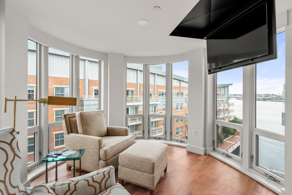 4 Battery Wharf, Unit 4604 Boston, MA 02109 - Photo 29 of 39 a living room with furniture and a floor to ceiling window