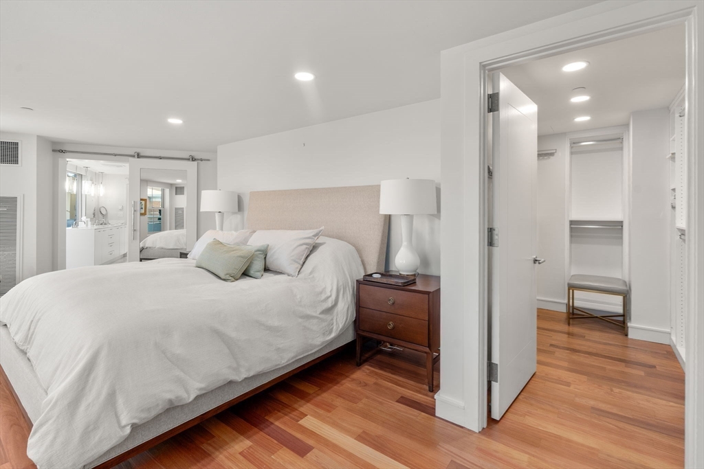 4 Battery Wharf, Unit 4604 Boston, MA 02109 - Photo 30 of 39 a spacious bedroom with a bed and a view of bathroom