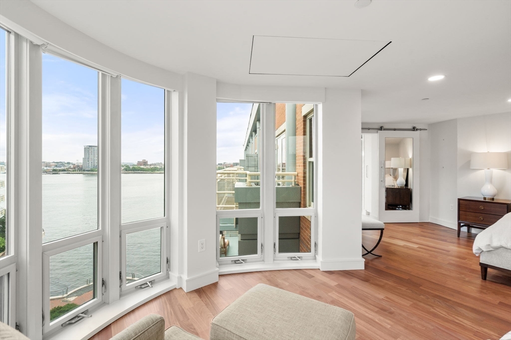 4 Battery Wharf, Unit 4604 Boston, MA 02109 - Photo 6 of 39 a view of a big room with wooden floor and windows