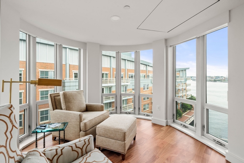 4 Battery Wharf, Unit 4604 Boston, MA 02109 - Photo 7 of 39 a living room with furniture and a floor to ceiling window