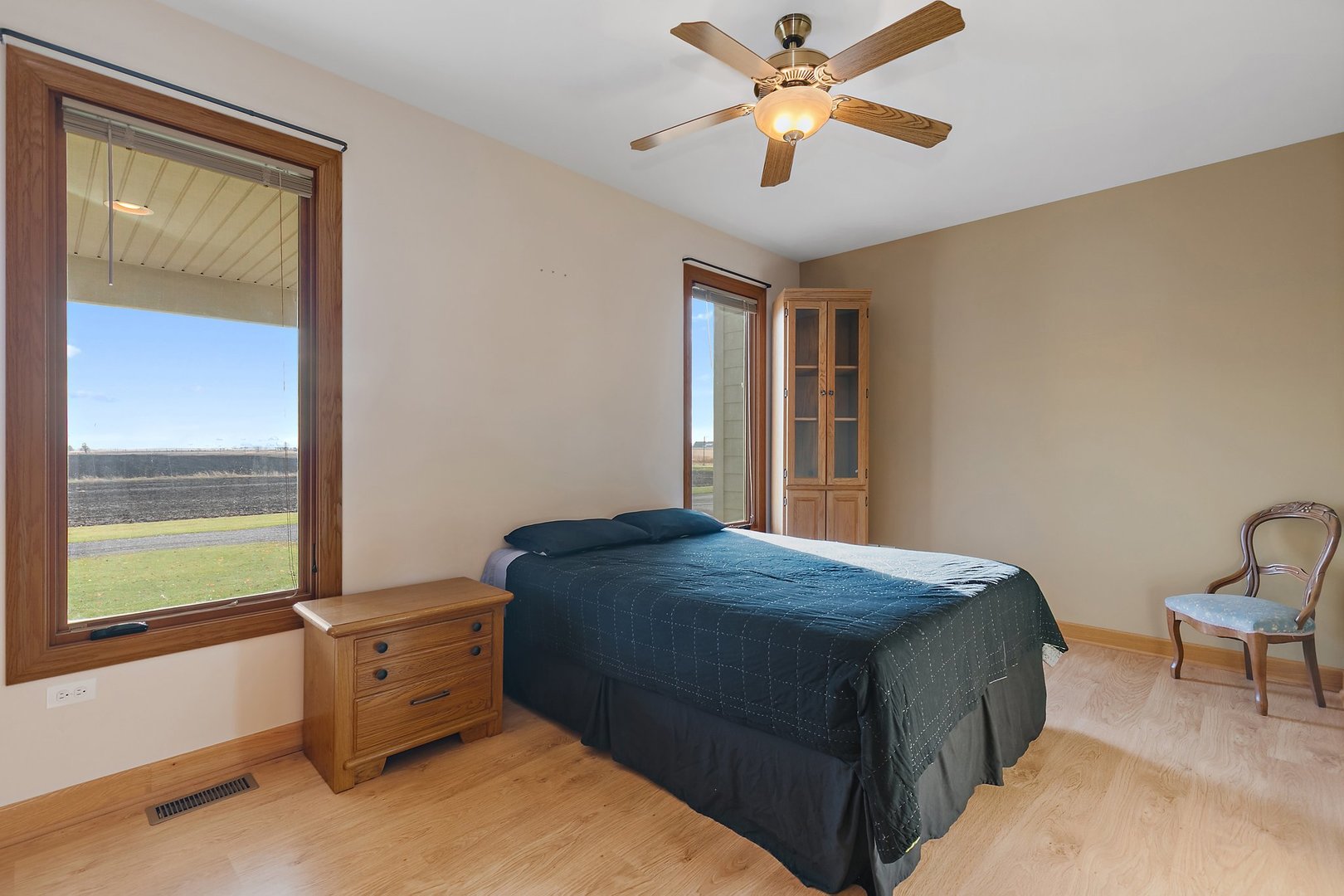 550 Maplewood Road Somonauk, IL 60552 - Photo 48 of 91 a bedroom with a bed and a chandelier