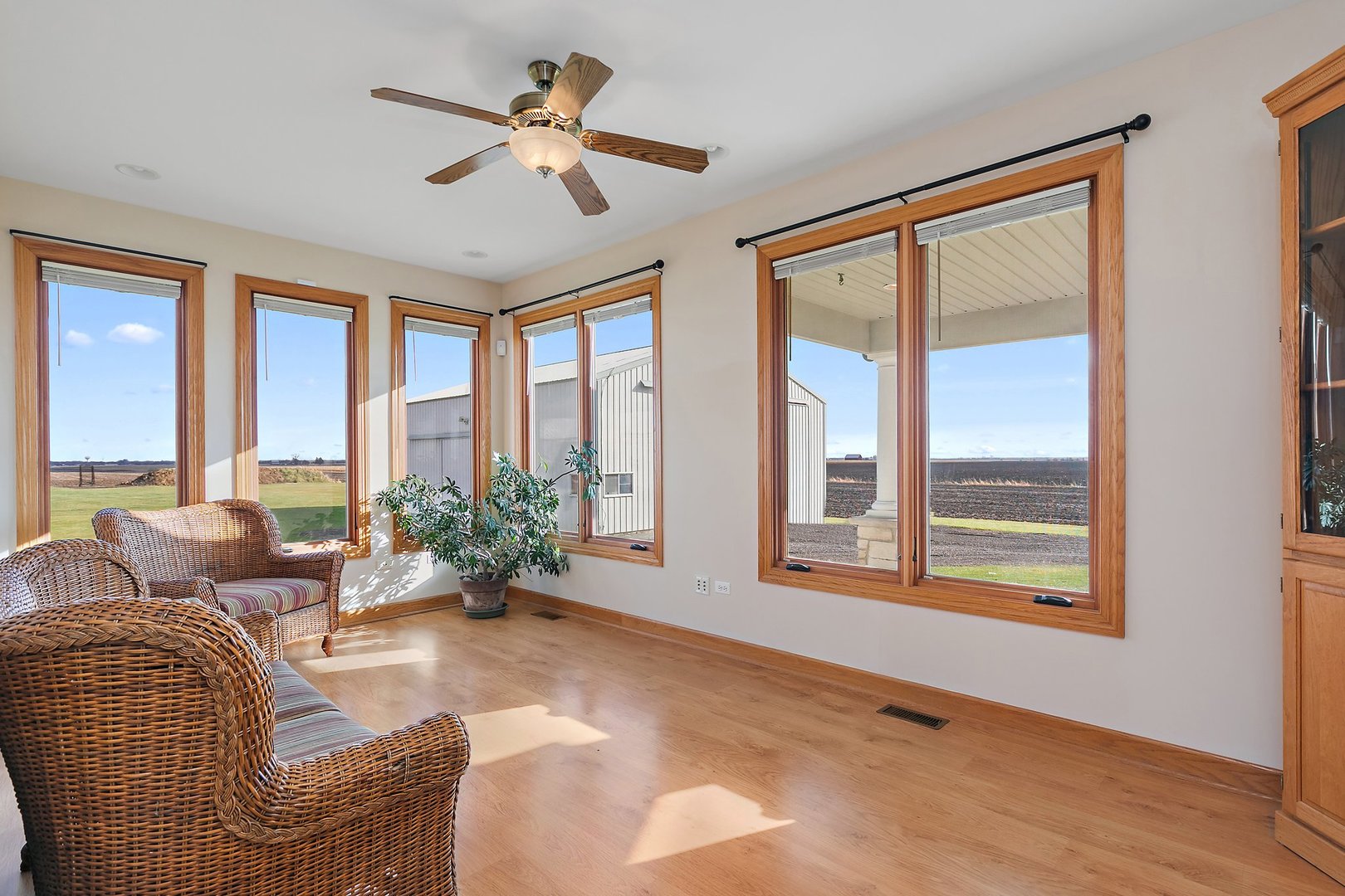 550 Maplewood Road Somonauk, IL 60552 - Photo 49 of 91 a living room with furniture large windows and a chandelier