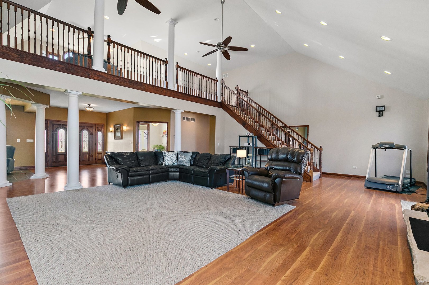 550 Maplewood Road Somonauk, IL 60552 - Photo 8 of 91 a living room with furniture stairs and a wooden floor