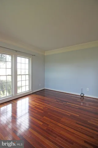 an empty room with fan and windows