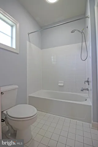 a spacious bathroom with a double vanity sink mirror and toilet