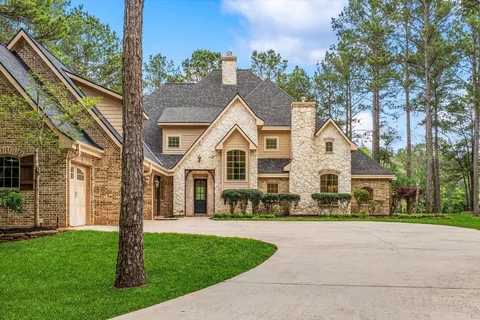 a view of a white house with a yard