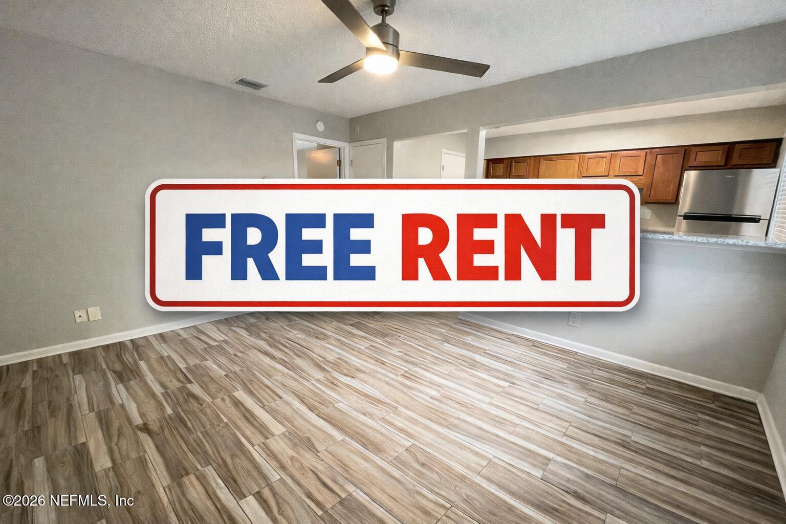 5404 101st Street, Unit 4 Jacksonville, FL 32210 - Photo 1 of 8 a street sign sitting on a wooden floor