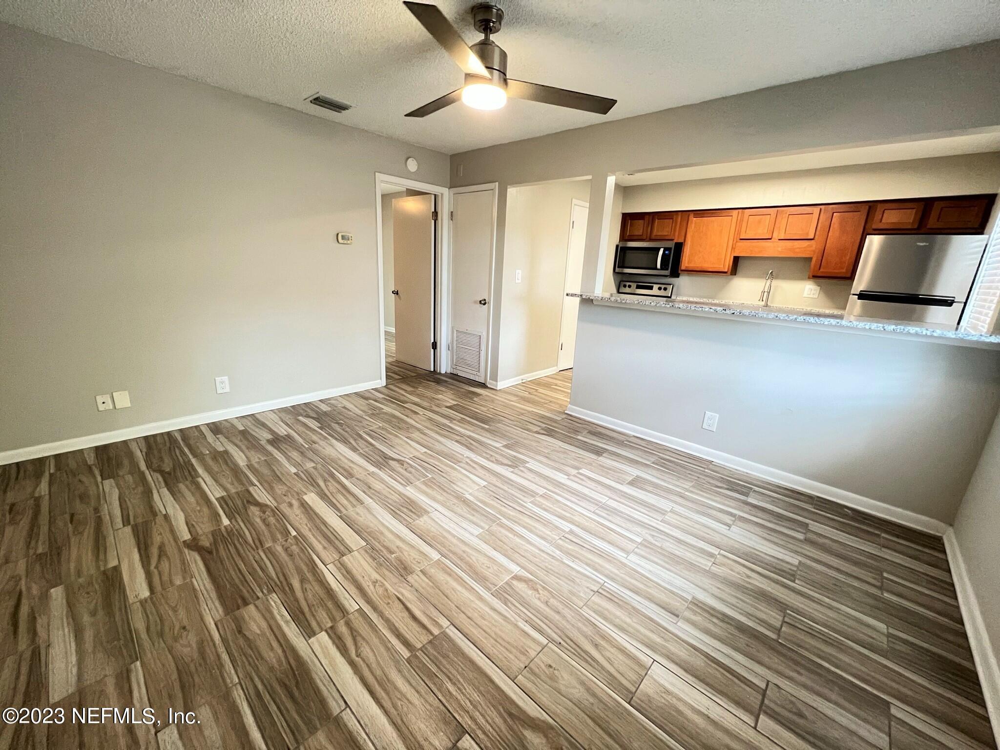 5404 101st Street, Unit 4 Jacksonville, FL 32210 - Photo 3 of 8 a view of an empty room with closet and a ceiling fan