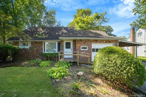 a house with green field in front of it