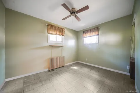 a view of an empty room and a ceiling fan