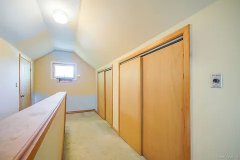 a view of a hallway with furniture and windows