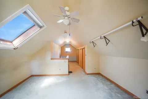 en empty room with windows and ceiling fan