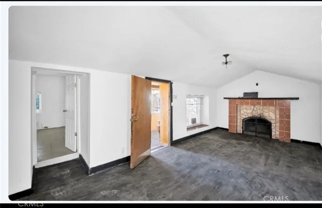 a view of an empty room with a fireplace