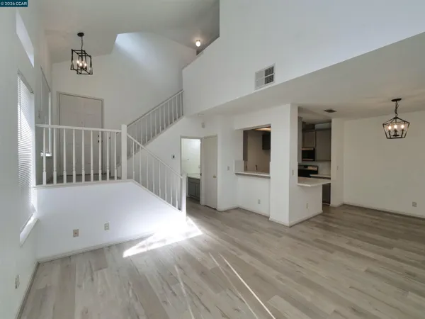 a view of a hallway with wooden floor and staircase