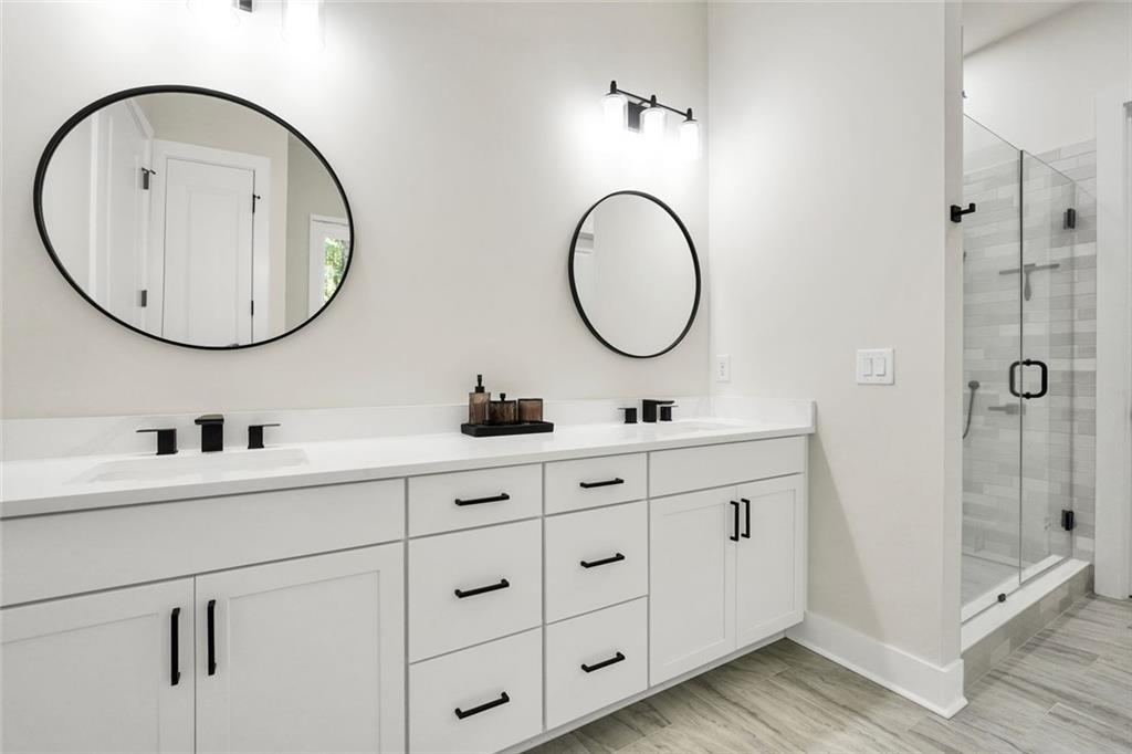 5567 Tyree Road Winston, GA 30187 - Photo 12 of 28 a bathroom with a double vanity sink and a mirror