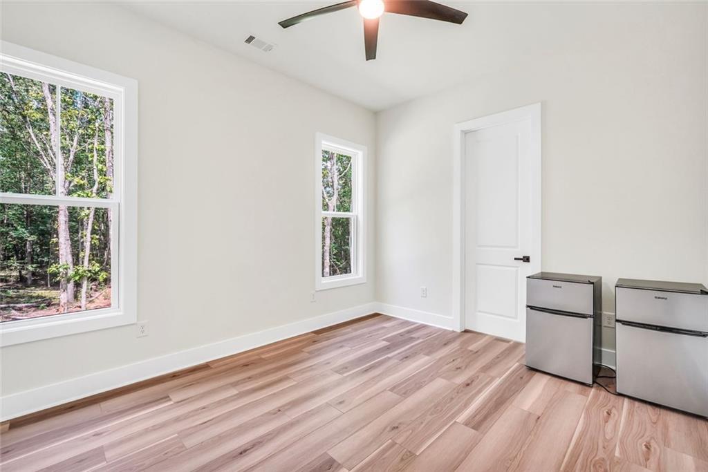 5567 Tyree Road Winston, GA 30187 - Photo 14 of 28 a view of empty room with wooden floor and fan