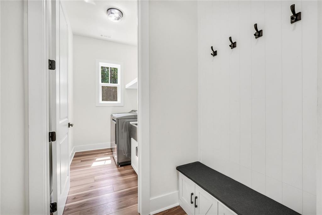 5567 Tyree Road Winston, GA 30187 - Photo 16 of 28 a view of a hallway with wooden floor and a bathroom