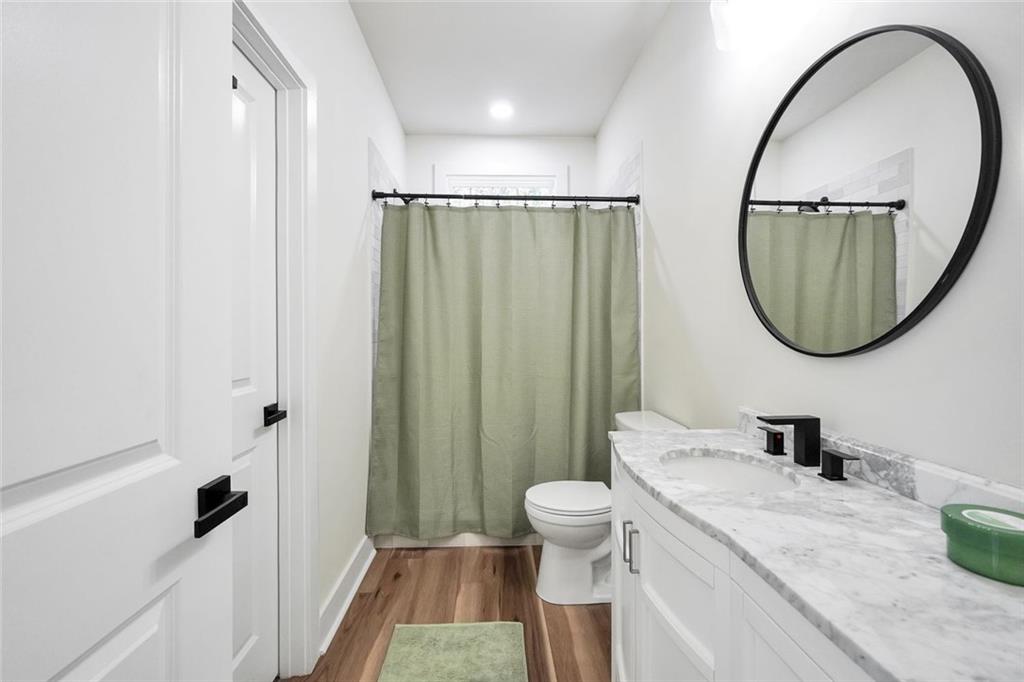 5567 Tyree Road Winston, GA 30187 - Photo 20 of 28 a bathroom with a granite countertop sink a toilet and a mirror