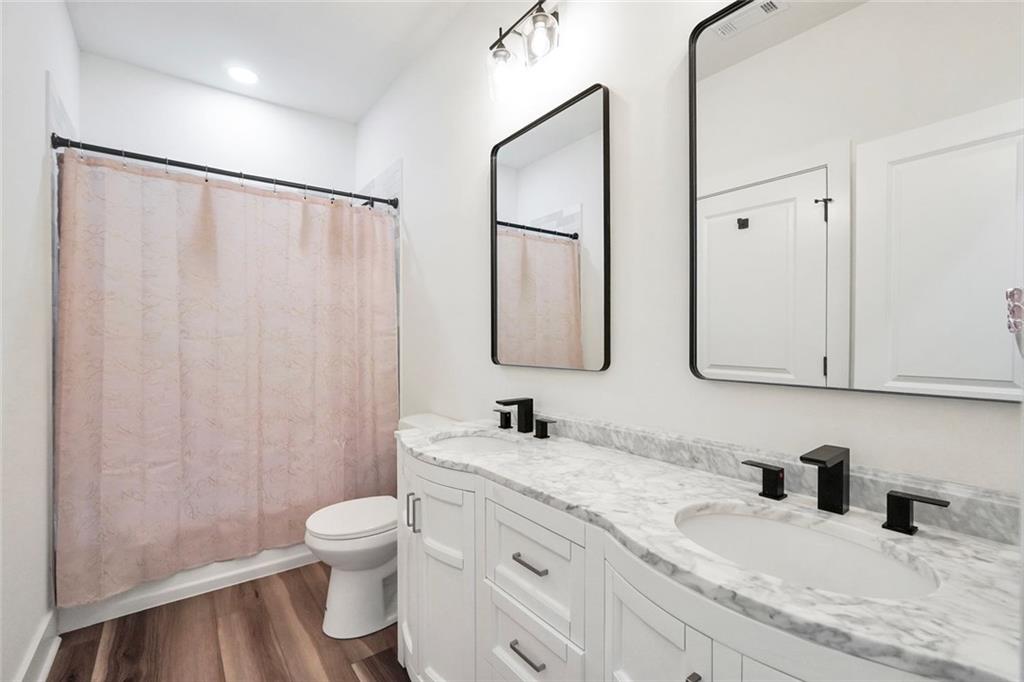 5567 Tyree Road Winston, GA 30187 - Photo 22 of 28 a bathroom with a granite countertop sink a toilet and a mirror
