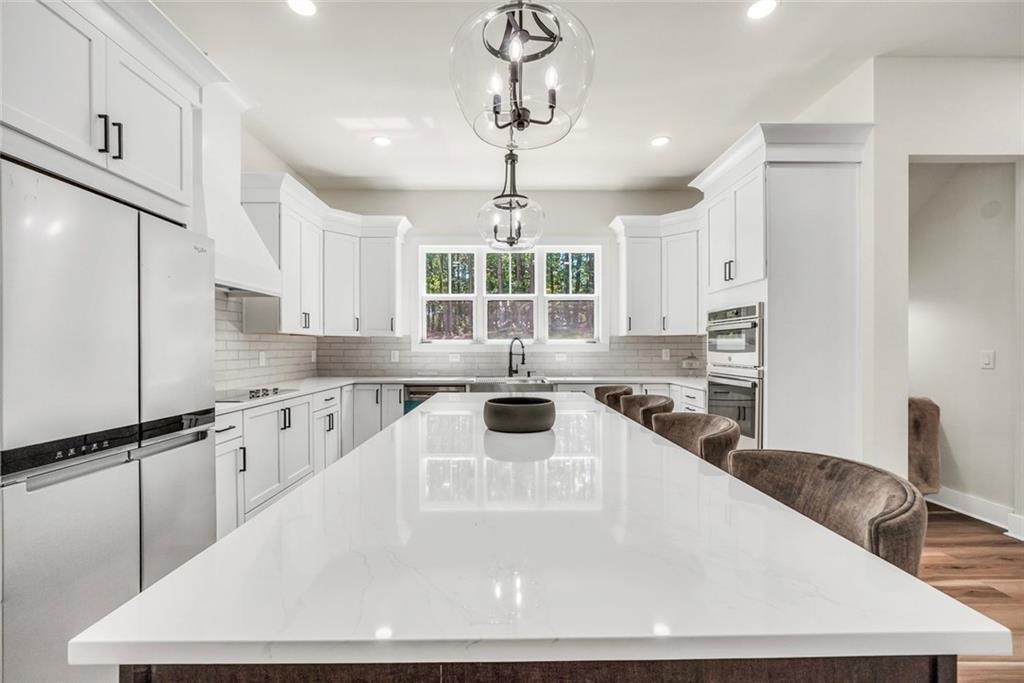 5567 Tyree Road Winston, GA 30187 - Photo 6 of 28 a kitchen with stainless steel appliances granite countertop a sink a stove and a refrigerator