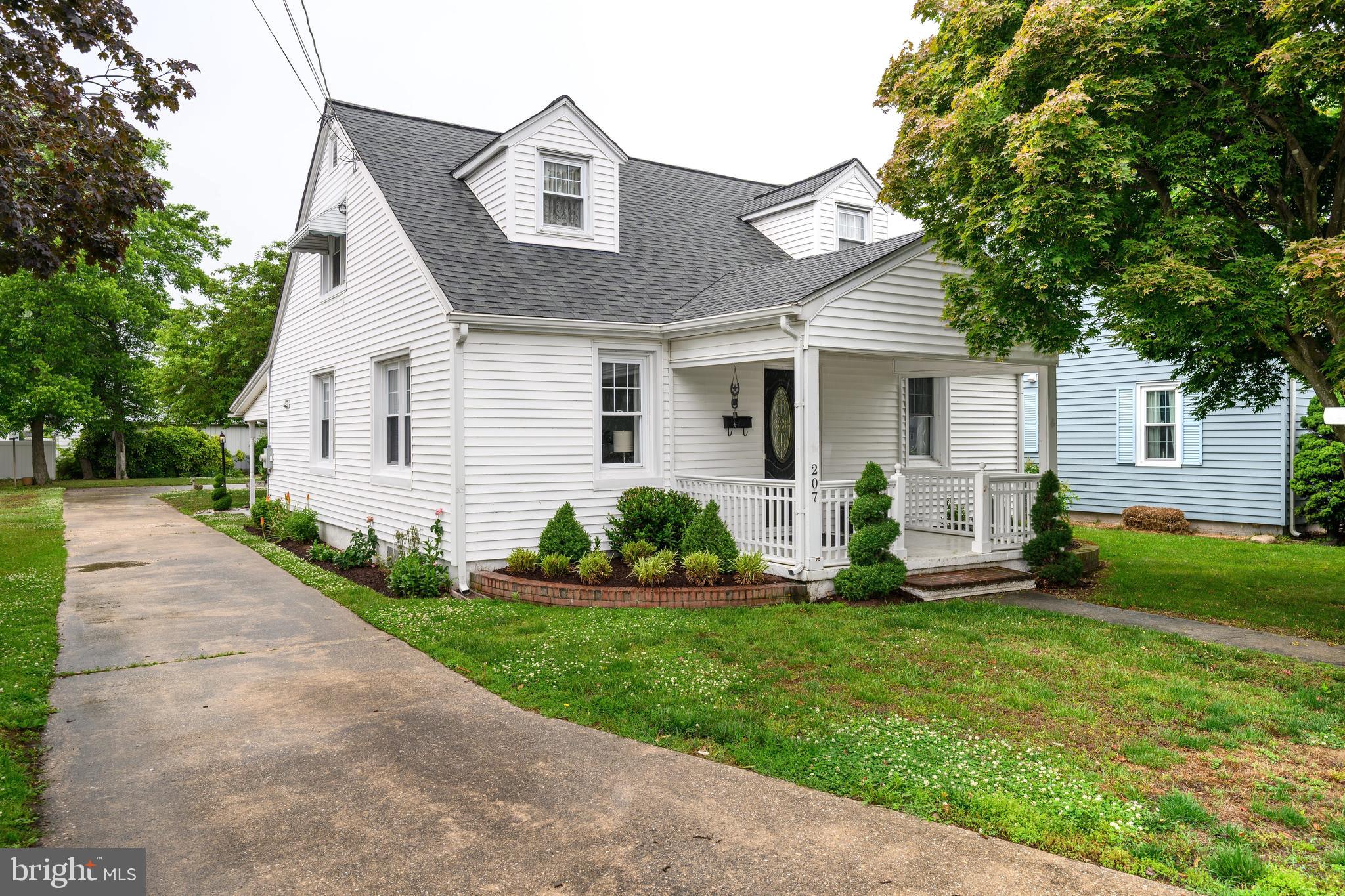 207 Crusader Road Cambridge, MD 21613 - Photo 5 of 76 a front view of a house with a yard and potted plants