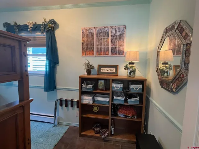 a living room with furniture a flat screen tv and a window
