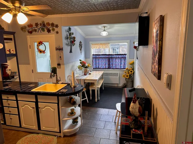 a living room with a table chairs and a wooden floor