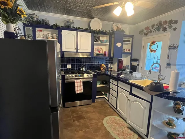 a room with a refrigerator and a television