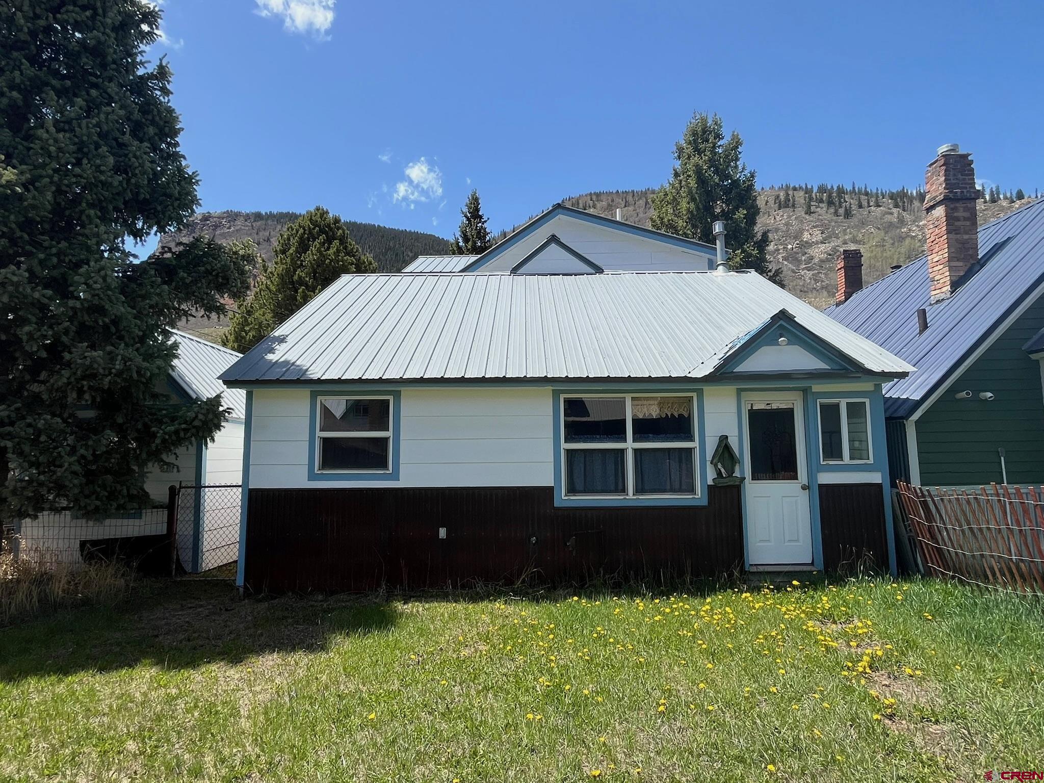 1250 Snowden Street Silverton, CO 81433 - Photo 2 of 34 a front view of a house with a yard and garage