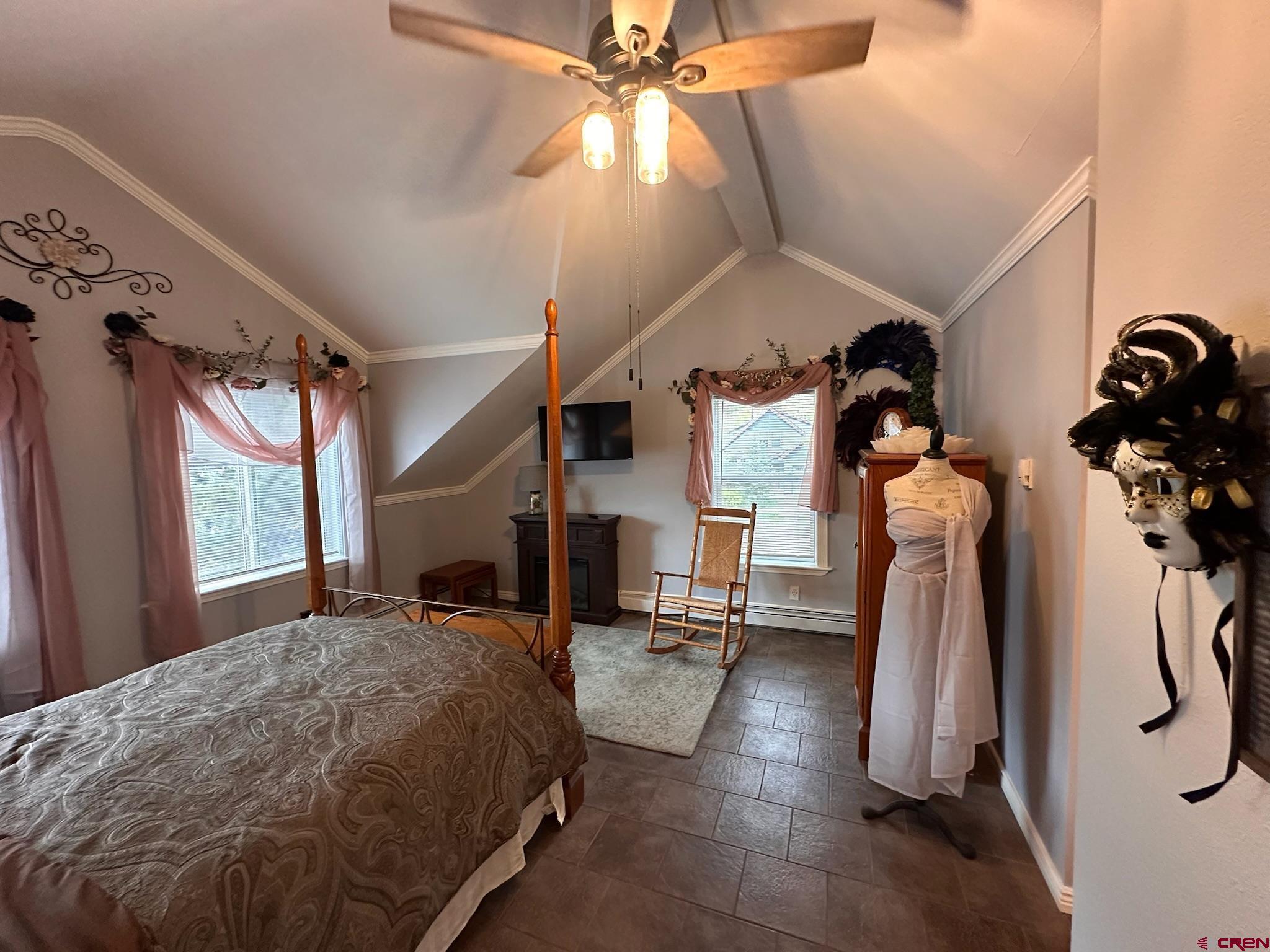 1250 Snowden Street Silverton, CO 81433 - Photo 30 of 34 a bedroom with a bed and a chandelier