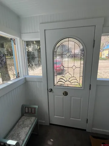 a living room with furniture a fireplace and a chandelier