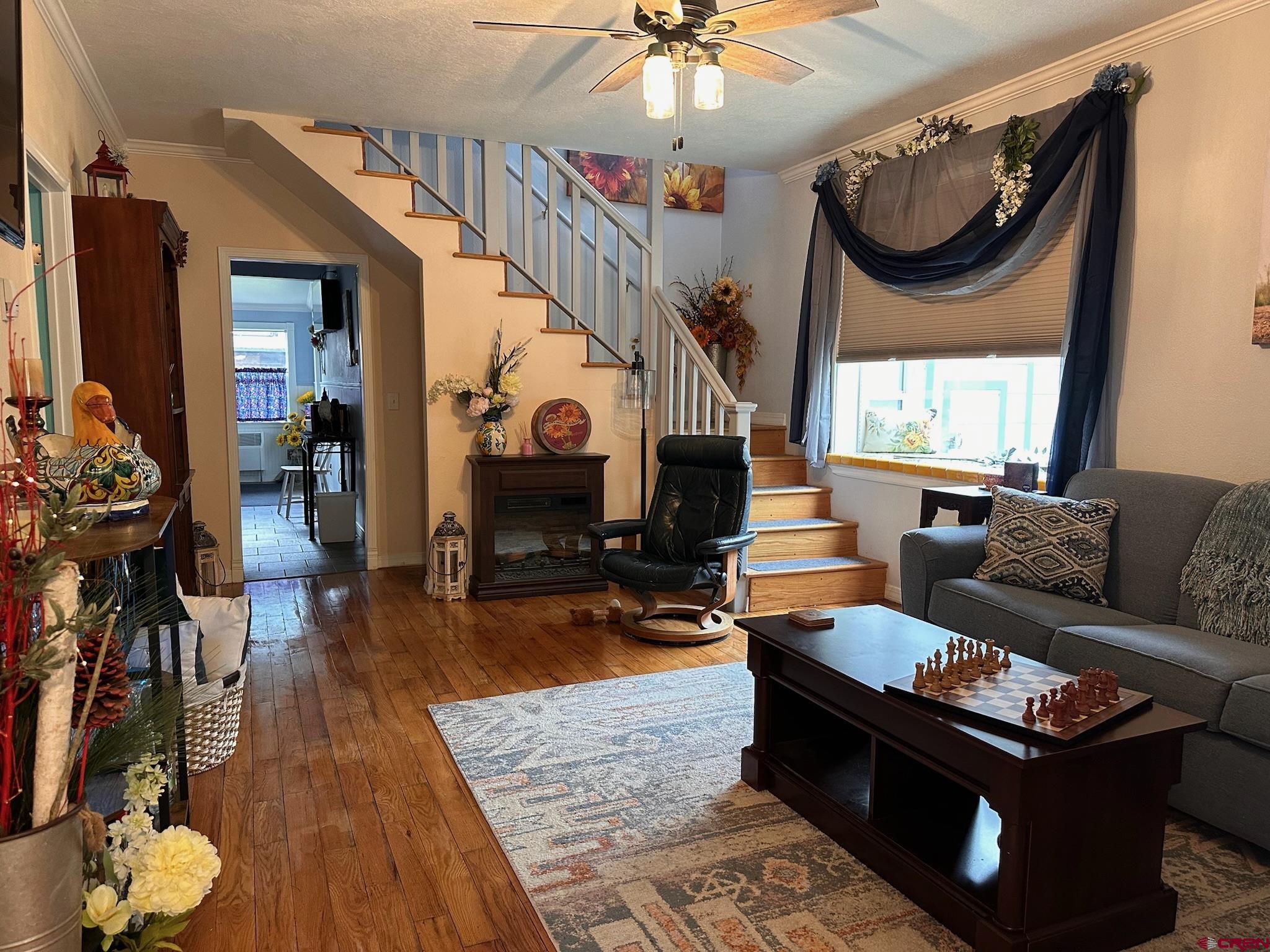 1250 Snowden Street Silverton, CO 81433 - Photo 7 of 34 a living room with furniture a fireplace and a chandelier