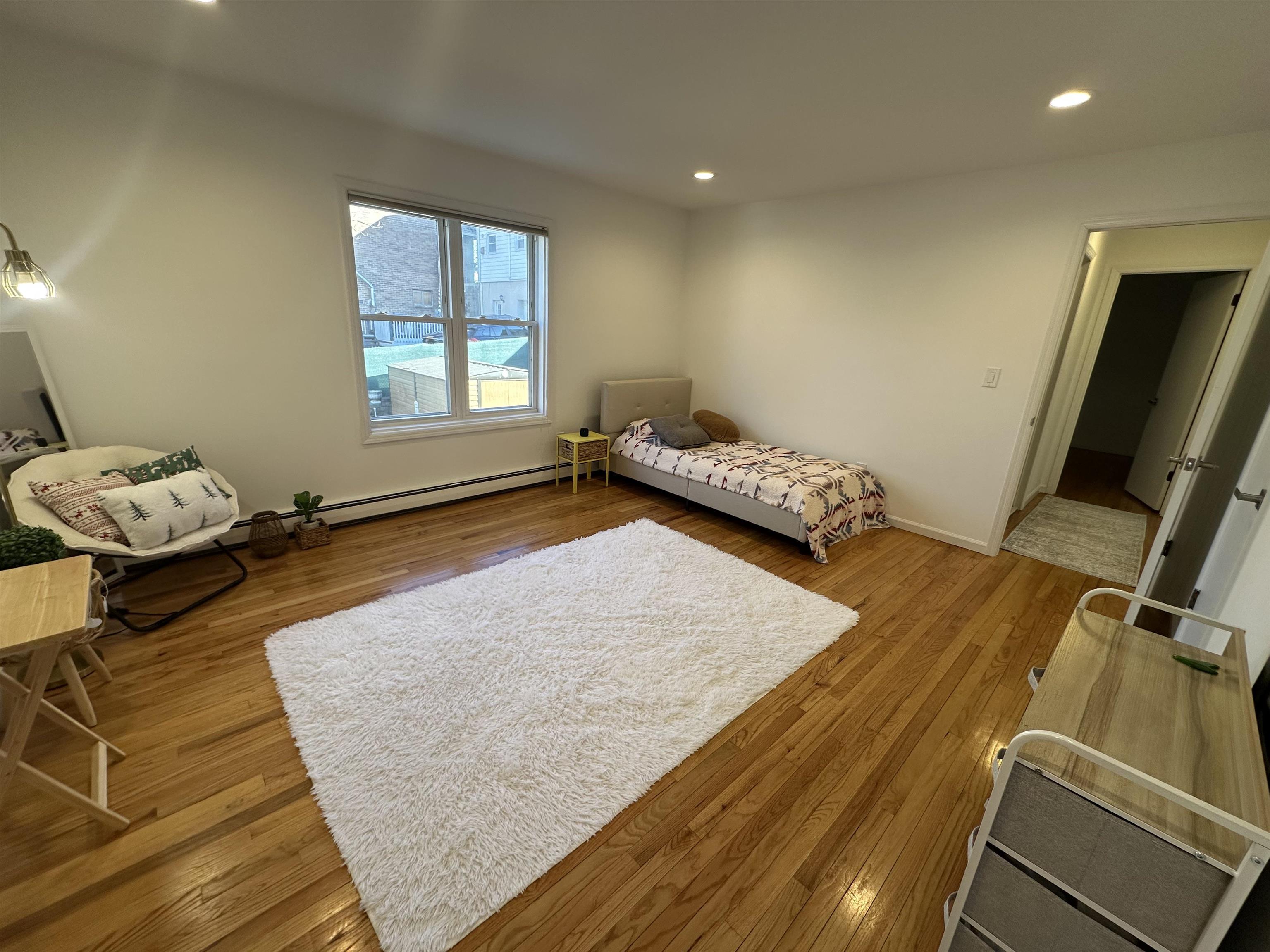 531 Day Avenue, Unit 1 Ridgefield, NJ 07657 - Photo 11 of 18 a bedroom with a bed and a window