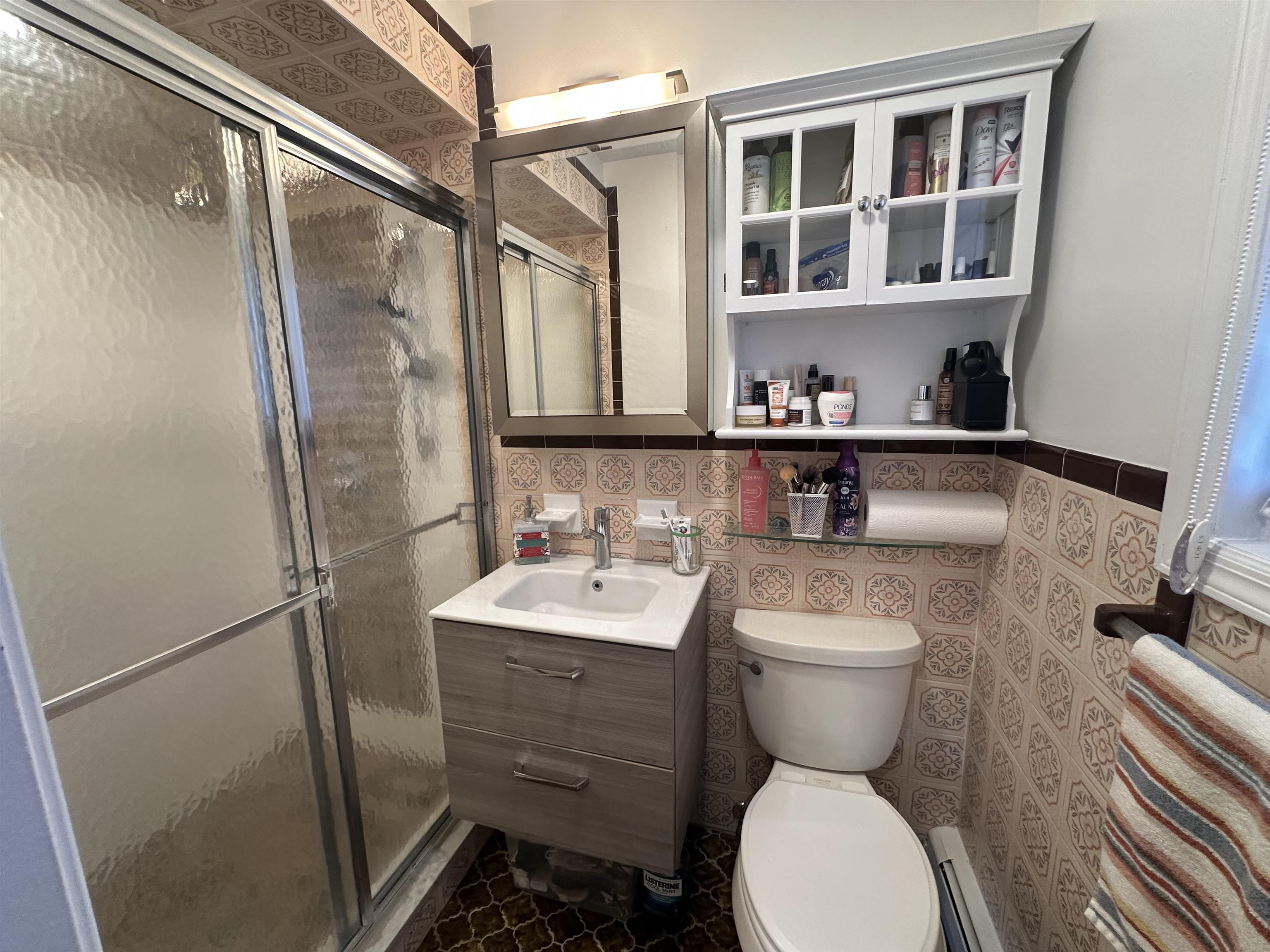 531 Day Avenue, Unit 1 Ridgefield, NJ 07657 - Photo 12 of 18 a bathroom with a toilet sink and shower