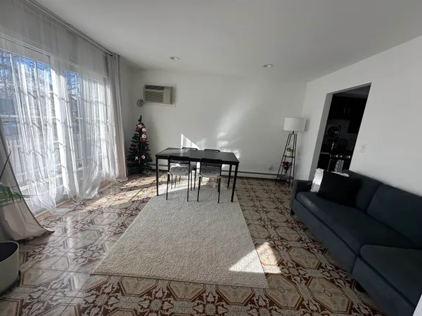 a living room with furniture and a piano