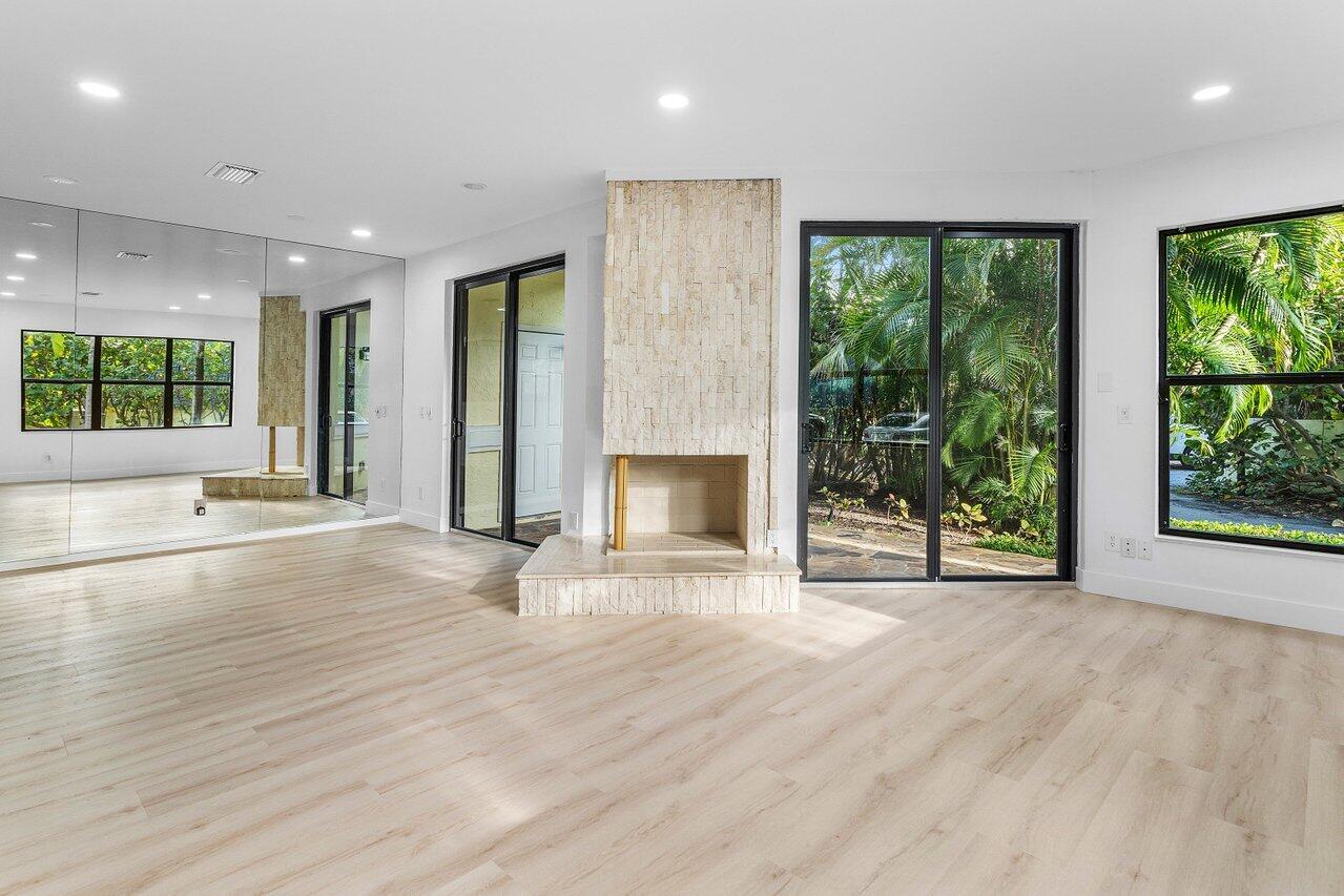 5109 North Ocean Boulevard, Unit H Ocean Ridge, FL 33435 - Photo 11 of 45 an empty room with large windows and a fireplace