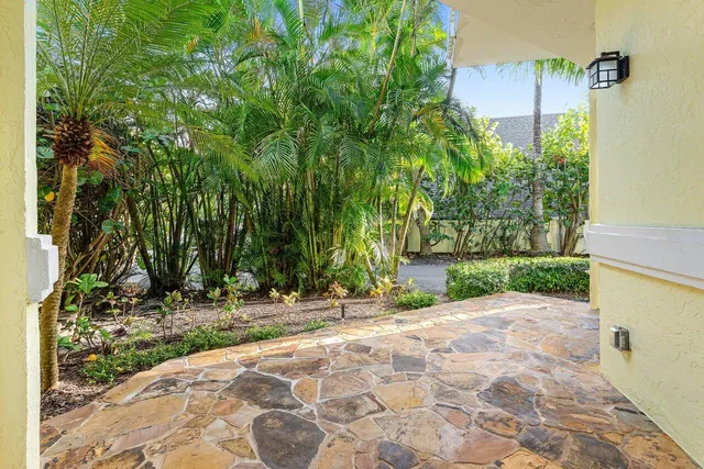 a view of a kitchen with kitchen island granite countertop wooden floor and stainless steel appliances