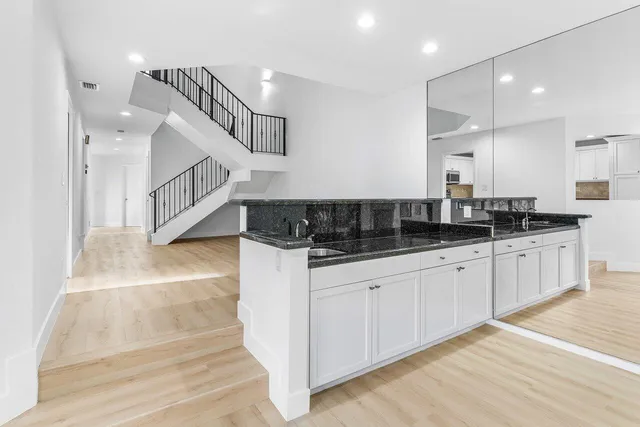 a kitchen with stainless steel appliances a refrigerator and a stove top oven