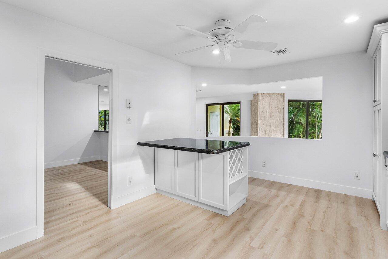 5109 North Ocean Boulevard, Unit H Ocean Ridge, FL 33435 - Photo 18 of 45 wooden floor in an empty room with a window